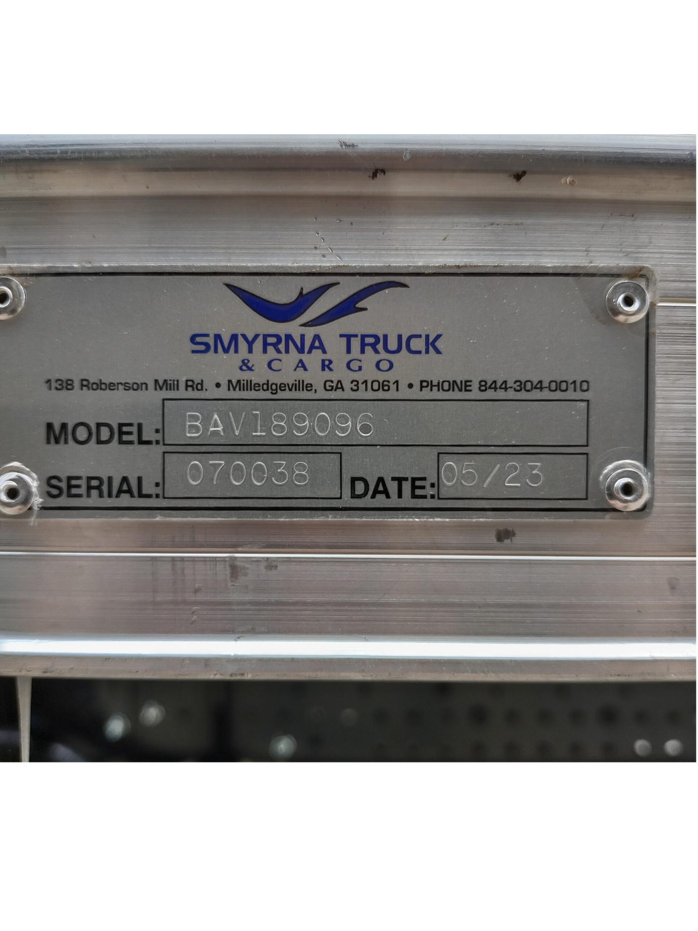 Smyrna Truck & Cargo vehicle identification plate on a metallic surface